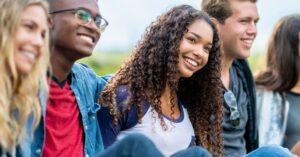 Youth Volunteer - youth smile together in the sun.